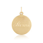 Gold pendant with 'Beau' engraved on a white background