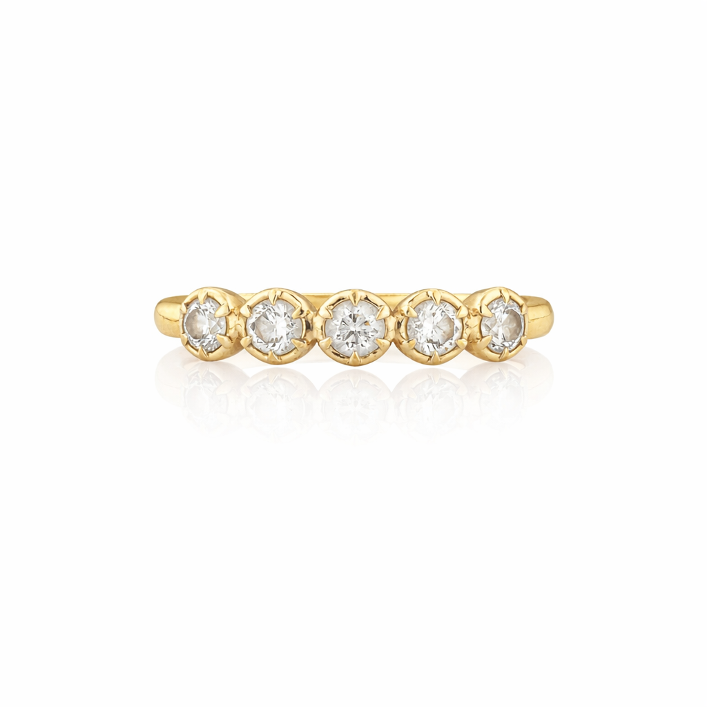 Gold ring with five diamonds on a white background