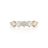 A Victorian style diamond ring with five stones set in a gold band with a buttercup setting.