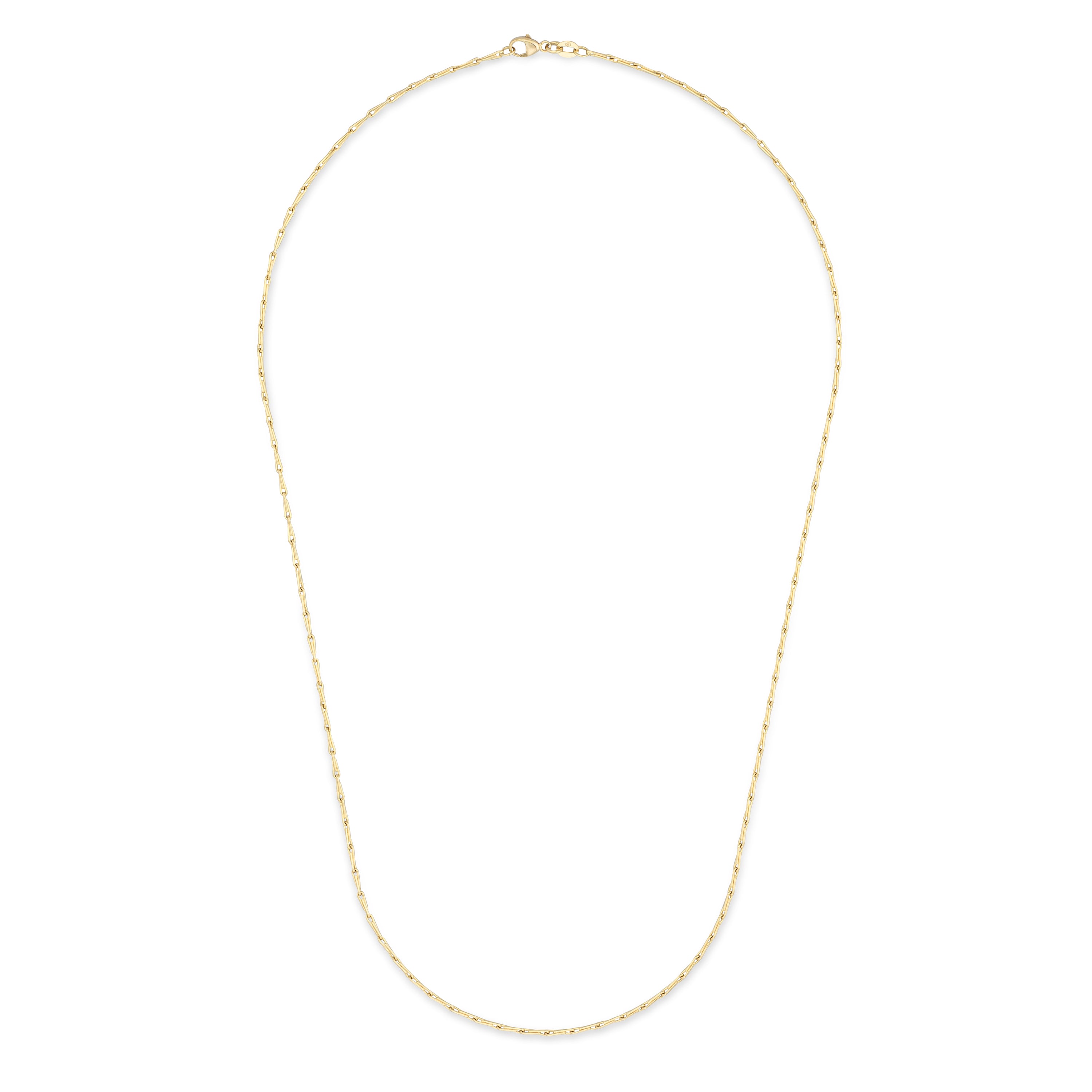 A delicate gold chain necklace arranged in an oval shape against a solid white background.