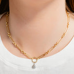 Gold chain necklace with a small pendant on a white background