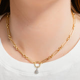 Gold chain necklace with a small pendant on a white background