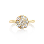 Gold ring with diamond cluster on a white background