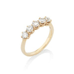 Gold ring with five diamonds on a white background