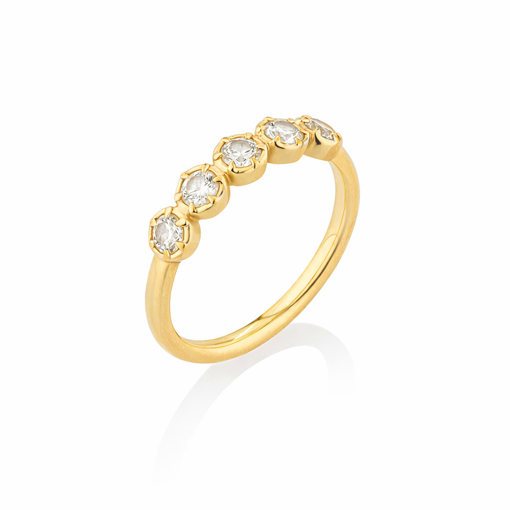 Gold ring with embedded diamonds on a white background