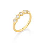 Gold ring with embedded diamonds on a white background