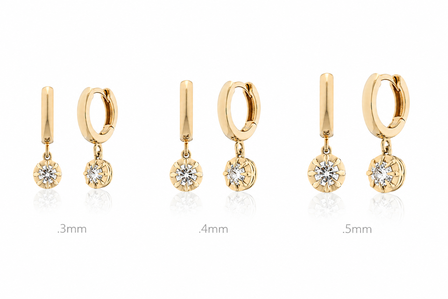  gold hoop and drop earrings with diamonds on a white background