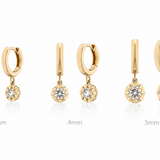  gold hoop and drop earrings with diamonds on a white background