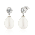 Pair of earrings with white teardrop stones and clear gemstones on a white background