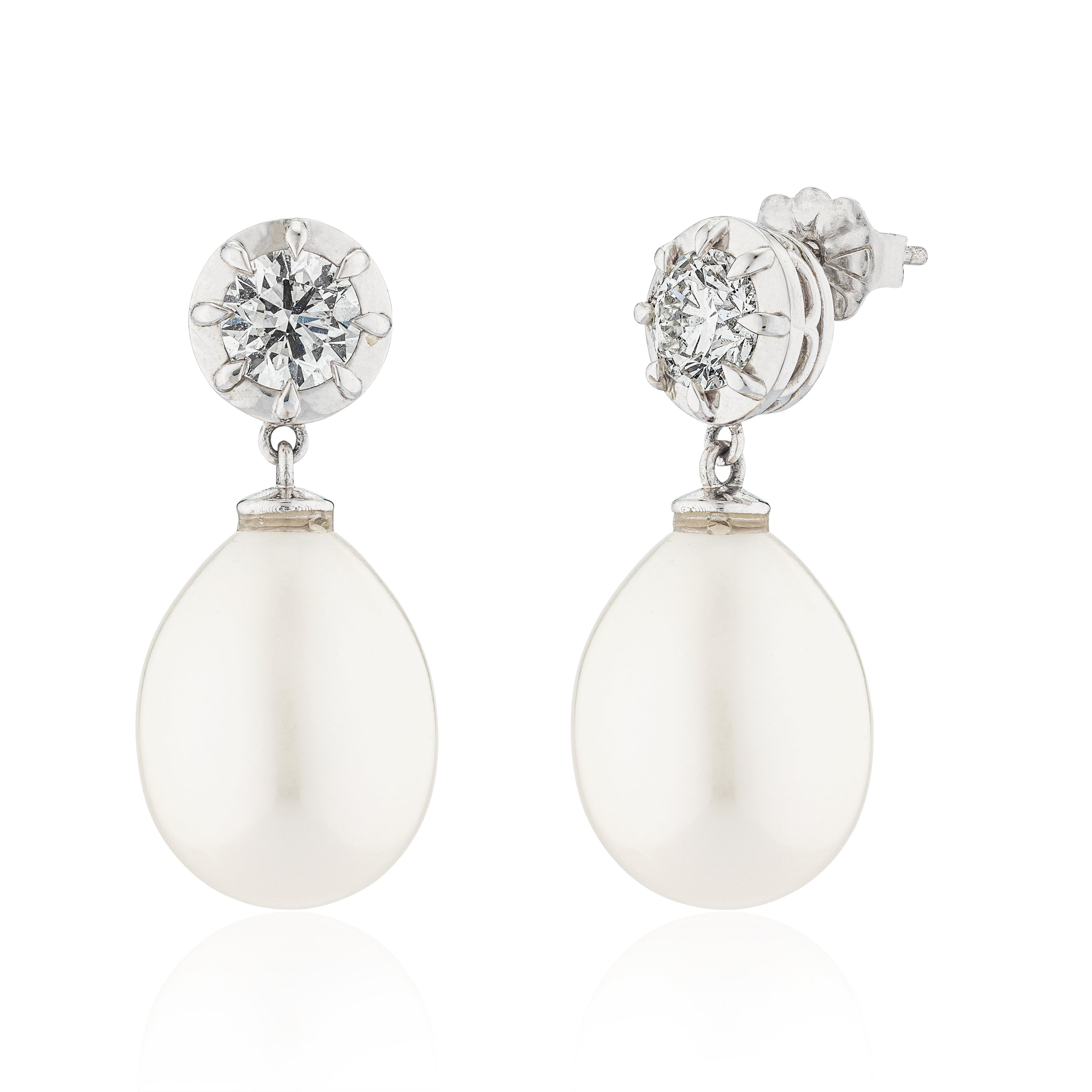 Pair of earrings with white teardrop stones and clear gemstones on a white background