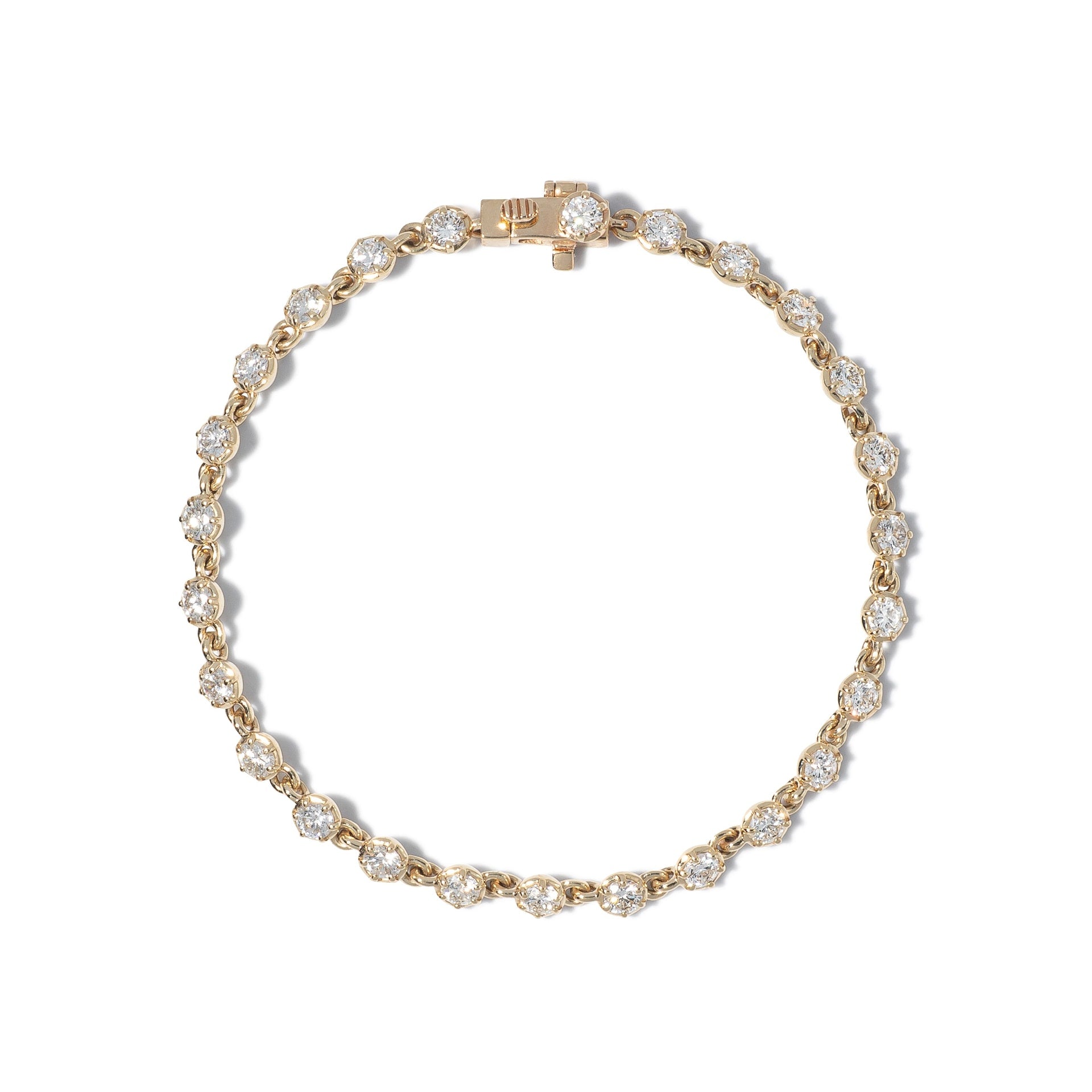 A close-up image of a gold tennis bracelet with mini collet settings featuring round brilliant diamonds.