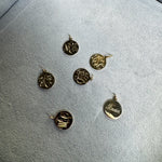 Gold pendants on a gray surface