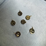 Gold pendants on a gray surface