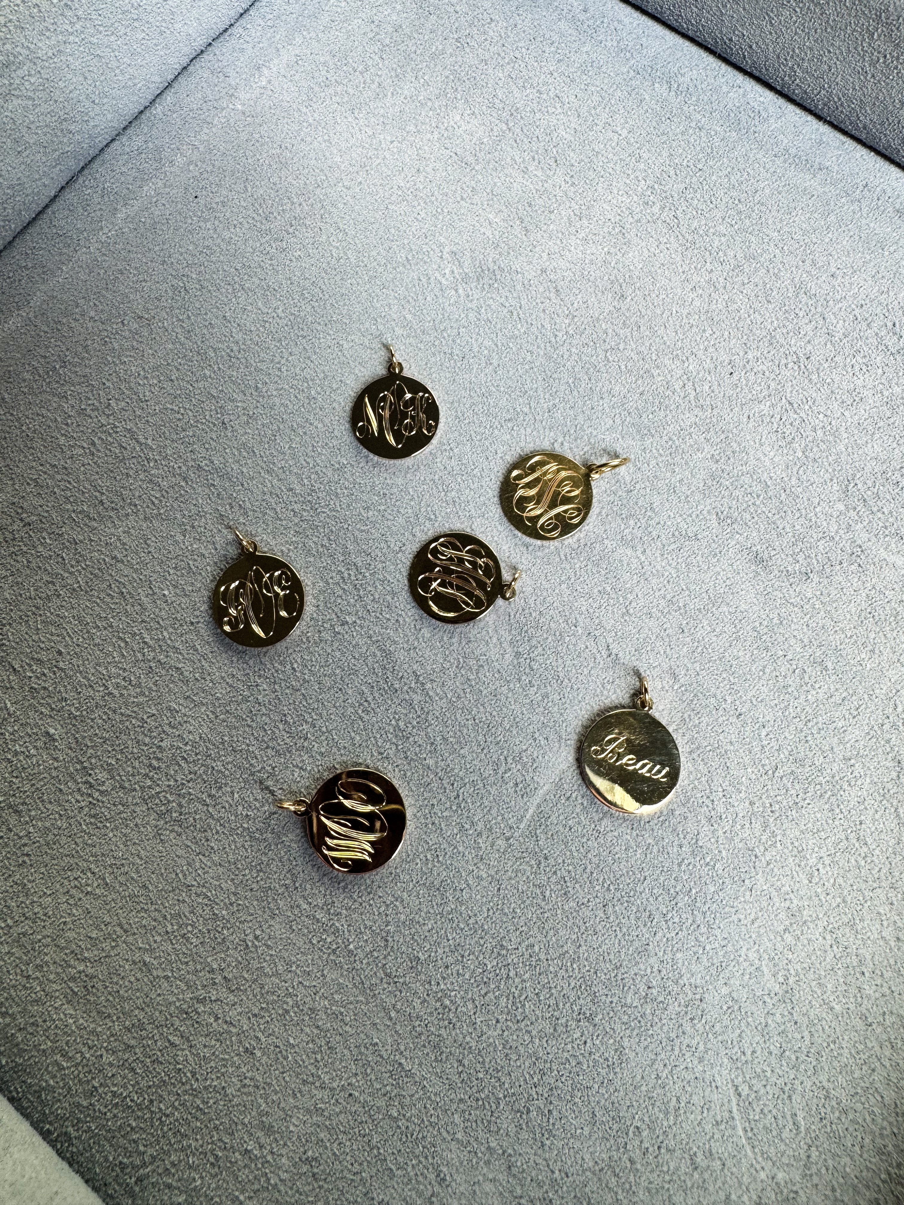 Gold pendants on a gray surface