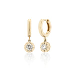 Gold hoop earrings with diamond drops on a white background