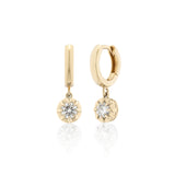 Gold hoop earrings with diamond drops on a white background